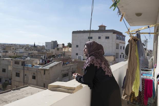 Maison looks out at the rooftops in Mafraq. She hopes to return to nursing in Syria once the conflict has ended.