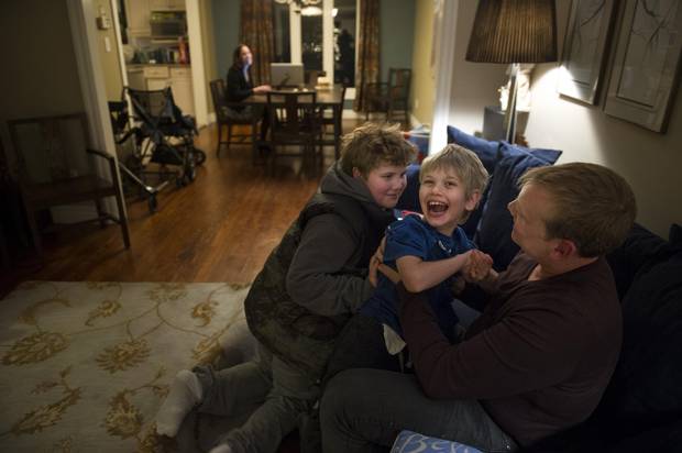 Keith McArthur and his sons sons Connor, 11, and Bryson, 9, play as mom Laura Williams looks on.
