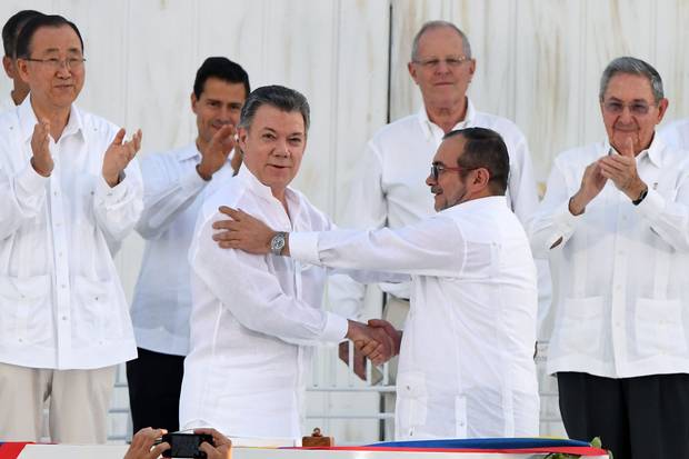Colombian President Juan Manuel Santos, left, shakes hands with FARC Rodrigo (Timochenko) Londono on Sept. 26 in Cartagena.