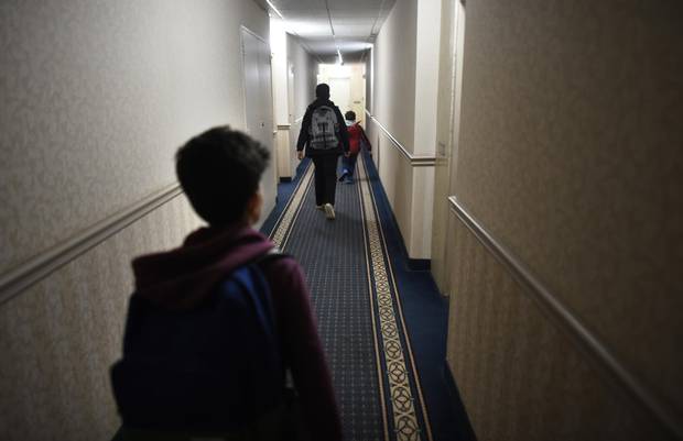 Ahmad's sons head down the hallway to their apartment after school was over at nearby Thorncliffe Park School.