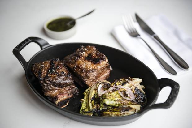 Grilled short ribs with chimichurri and grilled lettuce.