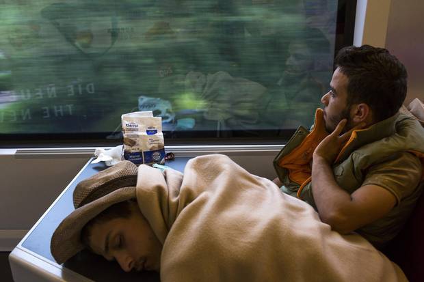 A Syrian refugee gazes out the window at the Austrian countryside while riding a train bound for Munich, Germany in September 2015.
