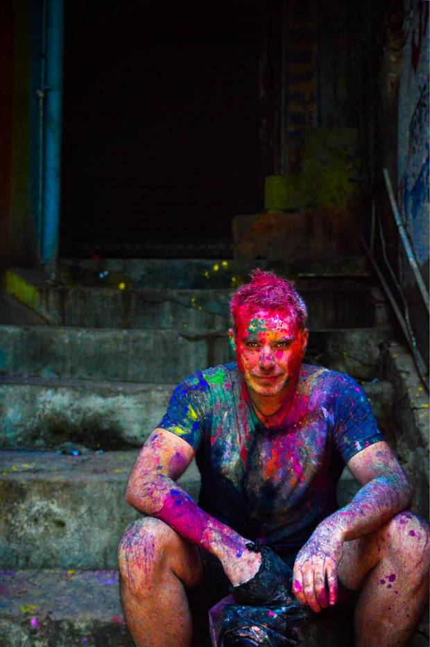 The author, Graeme McRanor, sits in a stairwell, face smeared with paint. 