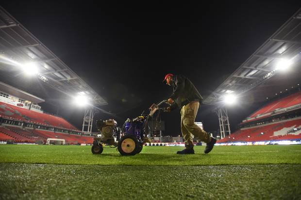 After the Grey Cup game, the ground crew worked late into the night measuring and painting lines on the field for the MLS match between Toronto and Montreal.