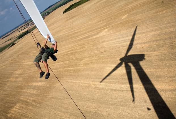 An engineer attends to a wind turbine blade at the Angermuende Wind Farm in Germany. 2006. Germany's renewable energy sector is among the most innovative and successful worldwide. By 2050 the country aims to power itself almost entirely on renewable sources including solar, wind and biomass energy.