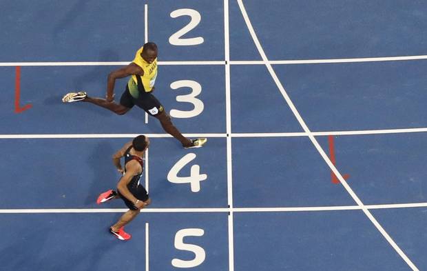 Usain Bolt crosses the line just ahead of Andre De Grasse in the 200-metre semi-finals on Wednesday night.