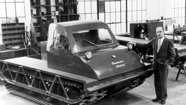 Joseph-Armand Bombardier, designer of the Bombardier snowmobile, stands beside the latest model on the production line of his Valcourt, Que. factory in this 1960 photo.