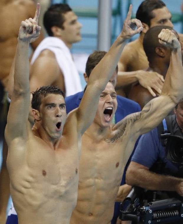 USA's Michael Phelps (L) and USA's Caeleb Dressel react after team USA won the Men's 4x100m Freestyle Relay Final during the swimming event at the Rio 2016 Olympic Games.