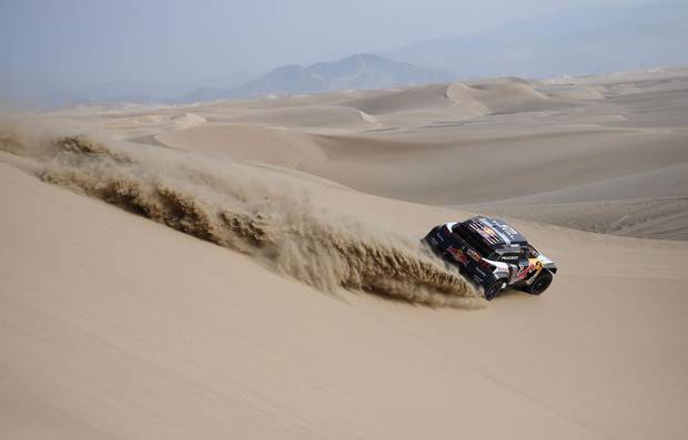 Peugeot's Spanish driver Carlos Sainz and co-driver Lucas Cruz compete during the 2018 Dakar Rally Stage 3 between Pisco and San Juan de Marcona in Peru, on January 8, 2018.