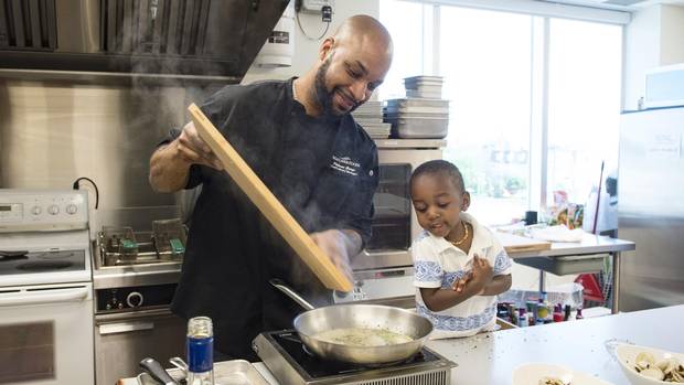 Chef Philman George and his son, Zaihman, prepare clams at High Liner Foods in Vaughan, Ont., on June 4.