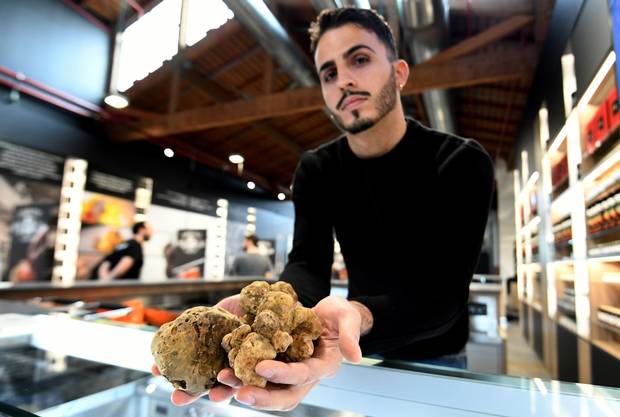 A vendor presents truffles at a stand during a press tour at FICO Eataly World agri-food park in Bologna on November 9, 2017. FICO Eataly World, said to be the world's biggest agri-food park, will open to the public on November 15, 2017.