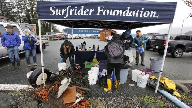 Volunteers unload and sort debris and garbage they found during the Surfrider Pacific Rim Christmas Jingle Cleanup Event along the Tofino harbour shorefront near the 4th Street government dock and marina on December 2, 2016.