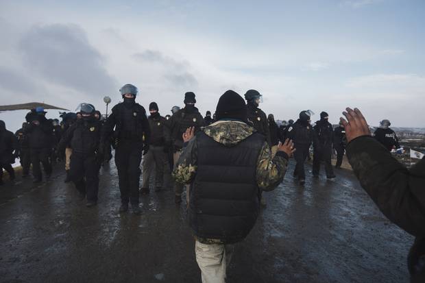 Police push people off the road after the deadline of an Army Corp of Engineers eviction notice at the DAPL resistance camps near Cannon Ball, North Dakota February 22.