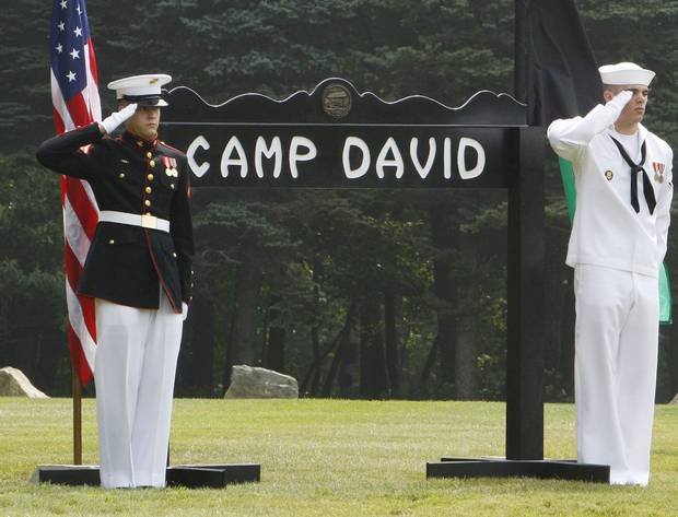 U.S. Navy and Marine personnel salute during a meeting between U.S. president George W. Bush and Afghanistan’s president Hamid Karzai at Camp David, Md., on Aug. 6, 2007.