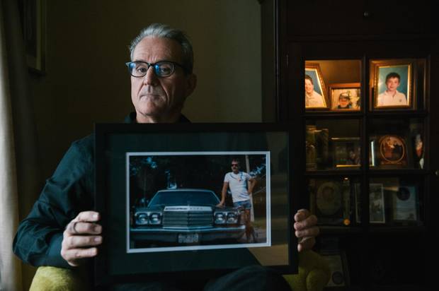 John Brady poses for a portrait at his home in Toronto on Nov. 2, 2017, with a favourite photo of his late brother, Conor. The photo, he says, represents Conor in his prime, when he was proud, healthy and confident, and is how John would like to remember him.