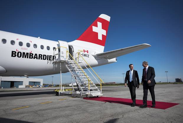 Fred Cromer, left, president of Bombardier Commercial Aircraft, and Rob Dewar, vice-president of the C Series Aircraft Program, walk past the new CS100 aircraft at a 2015 Toronto event.