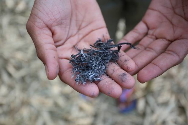 A man shows ash that has fallen in Bangladesh from Rohingya homes burned in Myanmar.