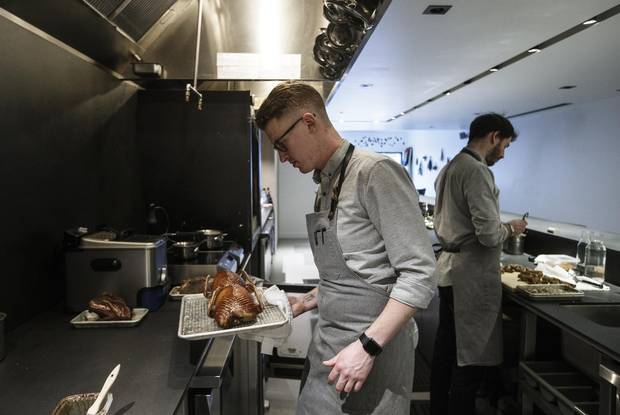 Chef and co-owner Ben Staley and co-worker Brandon Sim prepare duck.
