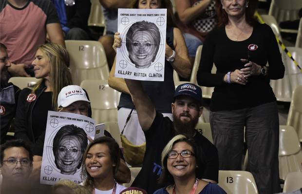 Supporters hold a poster of Hillary Clinton with a target over it at a Trump rally in Sarasota, Fla., on Nov. 7.