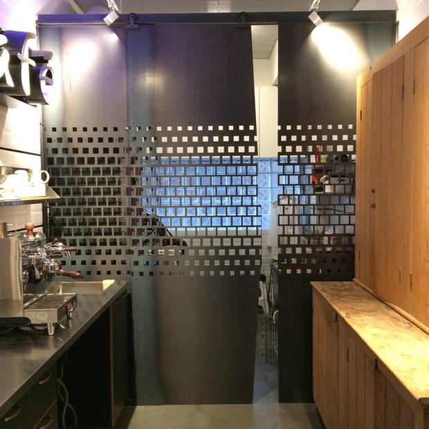 The cappuccino nook can be separated from the laundry room by a laser-cut metal screen.