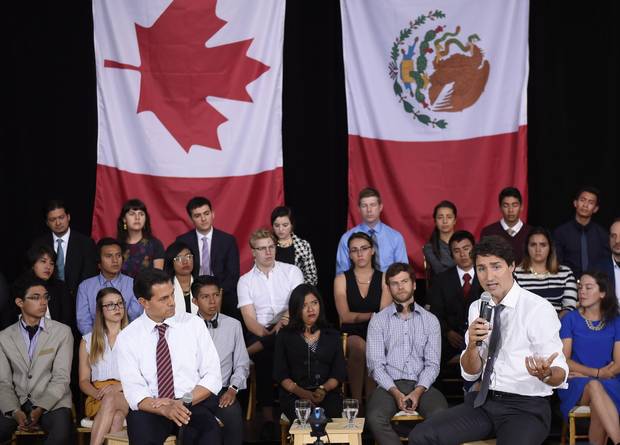 Canada's Prime Minister Justin Trudeau answers a question as Mexico's President Enrique Pena Nieto listens during a Q&A with youth at the Museum of Nature, on Tuesday, June 28, 2016 in Ottawa.