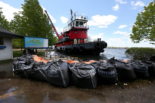 Radium Yellowknife loads large sandbags on the boat on Ward's Island to be moved to another spot where it is needed.