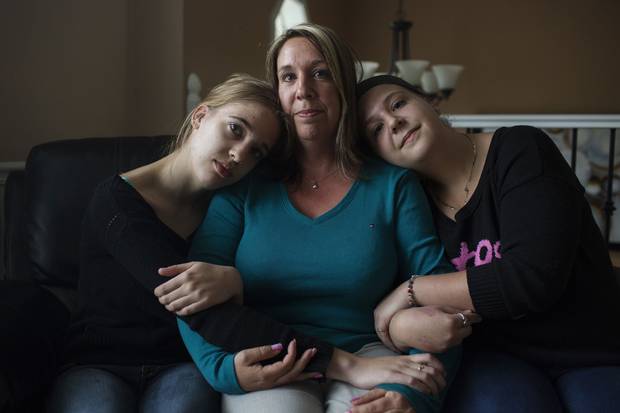 Hélène Bilodeau with her daughters Cloé, left, and Élody at their home in Geary, N.B. Her husband, Sgt. Paul Martin, died by suicide in September, 2011.