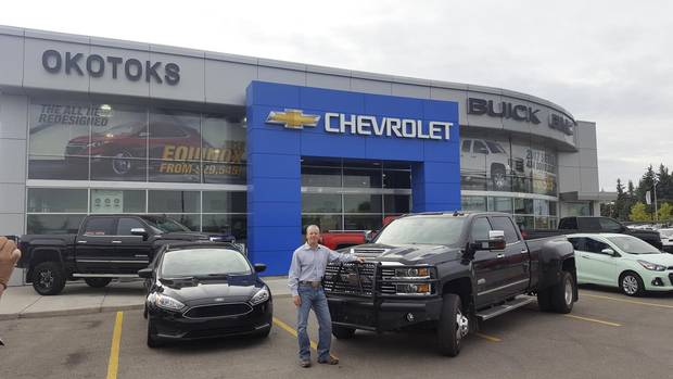 Rob Bowers and fiancee Breena Kotz pick up RobÕs new Chevy Silverado High Country Dually at a dealership in Okotoks, Alta. Rob puts on hundreds of thousands of kilometres each year, delivering trailers across Canada and the U.S. credit Doug FirbySlug is: gd-GM-104