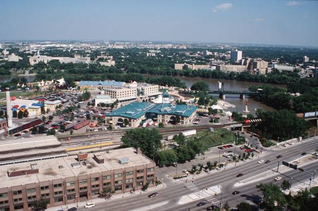 Businesses and parkland at the Forks, shown soon after redevelopment, are now major downtown attractions in downtown Winnipeg.