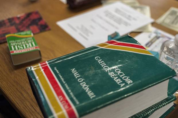 Irish dictionaries are seen on top of a table in a Turas classroom.