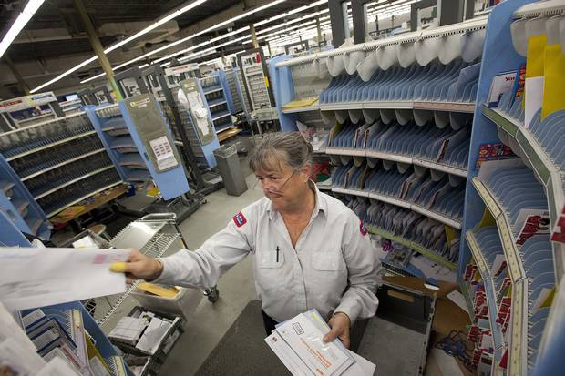 Canada Post employee Donna Yerxa sorts mail for her delivery route in Scarborough on Dec. 13, 2013.