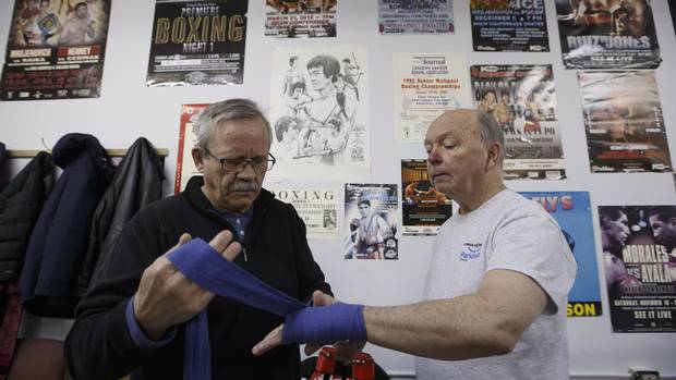 Provincial boxing coach Sylvio Fex wraps the hands of Larry Matier, as he prepares to take part in a boxing program for Parkinson's patients at Avenue Boxing Club in Edmonton.