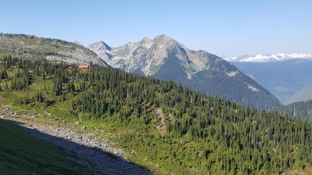 The chalet, red-roofed and dark wood, stands at an elevation of about 2,000 metres, on a forested knoll surrounded by peaks and glaciers and wildflowers. It is comfortable and rustic.