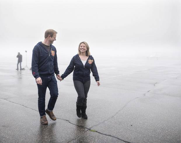 David Hein, left, and Irene Sankoff, the husband-and-wife writing team behind the musical Come From Away, hold hands walking off the tarmac at the Gander International Airport in Gander, N.L. on Sunday, October 30, 2016. Darren Calabrese/The Globe and Mail