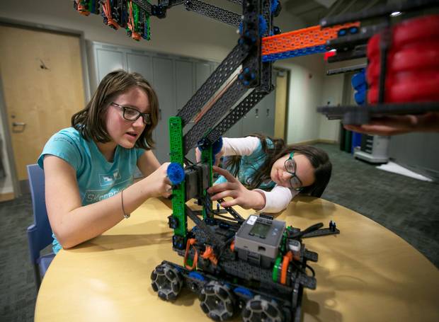 Katrina Usmar, left, and Samantha Sedran, students from St. Clement's School in Toronto, work on their robot Hexie in preparation for the upcoming Vex IQ Challenge Ringmaster. 
