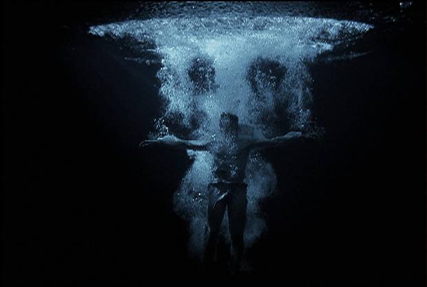 Bill Viola’s Ascension, 2000, shows a man plunging feet first into a pool of water.
