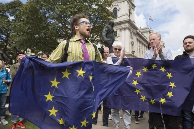 A protester holding a European Union (EU) flag, addresses a crowd as he demonstrates against the European Union (EU) referendum result, in London, U.K., on Saturday, June 25, 2016. The U.K. voted to quit the European Union after more than four decades in a stunning rejection of the continent's postwar political and economic order.