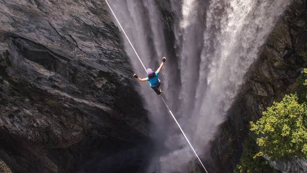 Mia Noblet walks on a 222-metre-long slackline at Hunlen Falls in B.C.'s Tweedsmuir South Provincial Park. The line is 400 metres above the water below. There is a burgeoning subculture around extreme versions of slacklining, a type of tightrope walking. Credit to Levi Allen at Leftcoast Media House