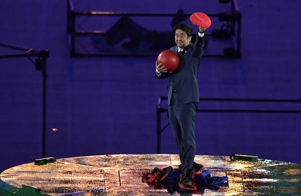 Japanese Prime Minister Shinzo Abe holds a red ball during the closing ceremony of the Rio 2016 Olympic Games at the Maracana stadium in Rio de Janeiro on August 21, 2016. 