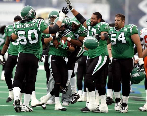 Saskatchewan Roughriders (# 83) Andy Fontuz holds the game winning ball he caught for a touchdown in overtime to beat the B.C. Lions as the rest of the team celebrates on Sunday Sept.24, 2006 at Taylor Field in Regina.