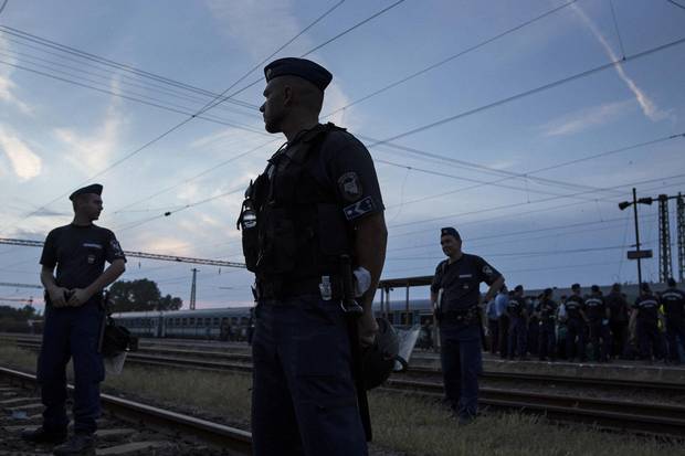 Police stand guard at the Bicske train station in Budapest.