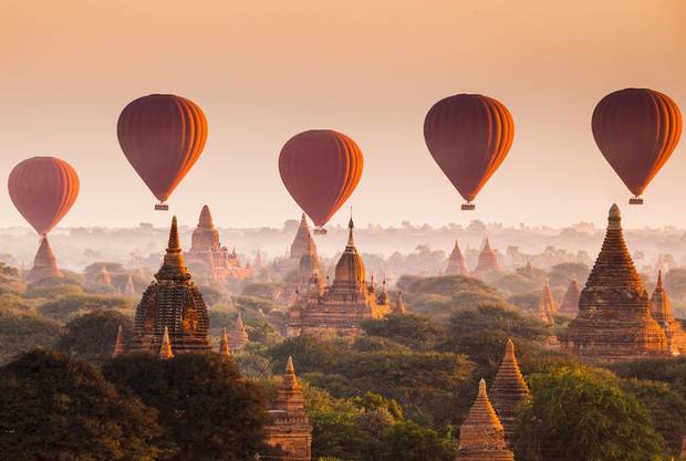 Bagan, Myanmar’s 11th century archaeological zone of more than 2,000 ancient pagodas gives rise to an iconic photo opportunity when hot-air balloons provide wide-angle views of its flat plain.