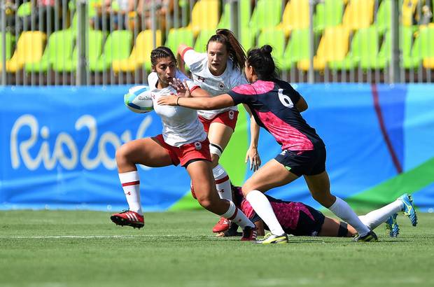 Canada's Bianca Farella runs with the ball as Japan's Ano Kuwai atempts to takle during women's sevens rugby action at the 2016 Olympic Games in Rio de Janeiro, Brazil on Aug. 6, 2016.