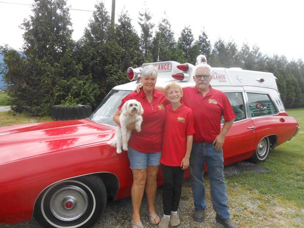 Fraser and Dorothy Field stand with their grandson Lucas, 12, in front of their 1969 Pontiac Superior Ambulance.
