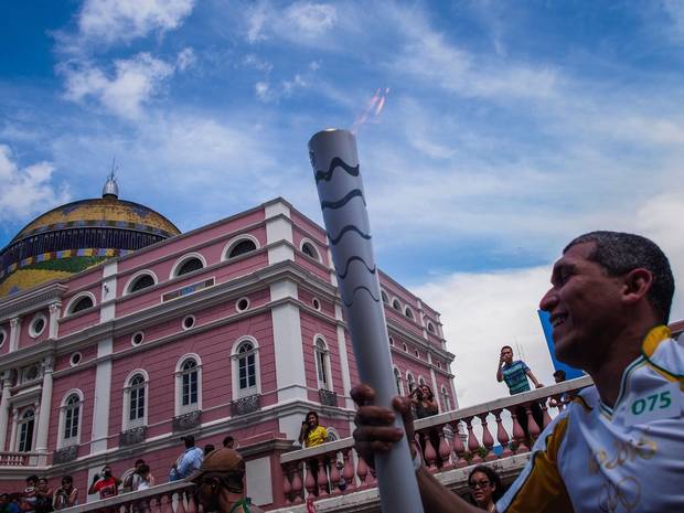 Euler Ribeiro Filho, carries the Olympic torch upon arrival in Manaus in front of the Amazon Theatre.