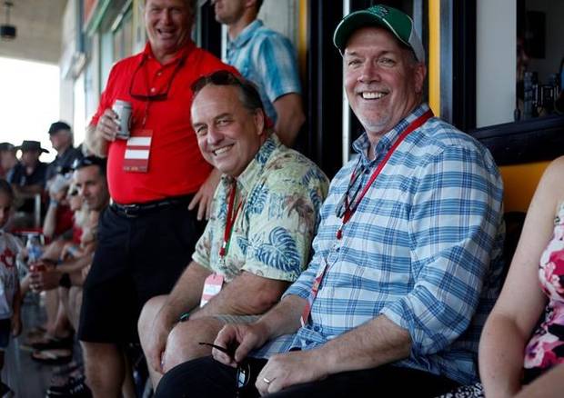 B.C. Green party leader Andrew Weaver and B.C. NDP leader John Horgan take in the final match between Team Canada and New Zealand during cup final action at the HSBC Canada Women's Sevens rugby event in Langford, B.C., on Sunday, May 28, 2017.