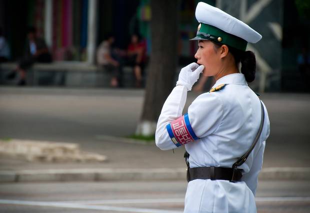 A traffic official directs vehicles in North Korea.