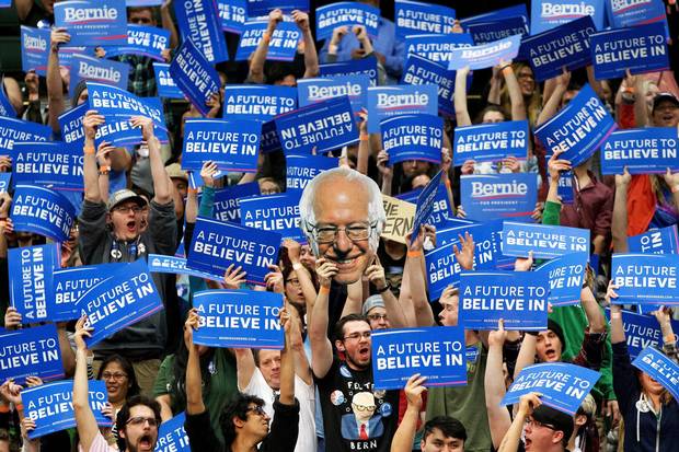 Students and supporters of Bernie Sanders cheer and hold up signs during a campaign rally at Colorado State University in Fort Collins in February.