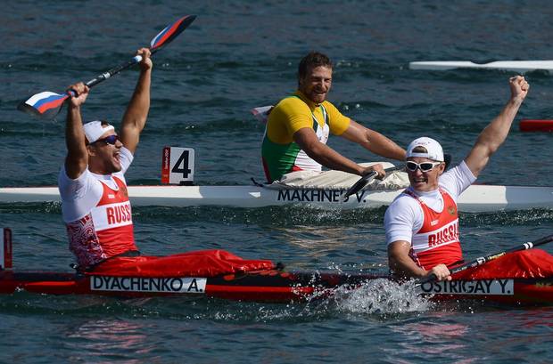 This file photo taken on August 11, 2012 shows Russia's Yury Postrigay (R) and Alexander Dyachenko celebrating after winning the gold medal in the kayak double (K2) 200m men's final A during the London 2012 Olympic Games, at Eton Dorney Rowing Centre in Eton, west of London. Canoeing's governing body has banned five Russians, including a gold medallist and a five-times world champion, from next month's Rio Olympics after an explosive independent report revealed state-run doping across Russian sport. 