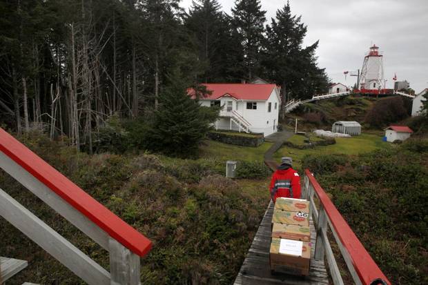 Lighthouse keeper Karen Zacharuk carries supplies back to base at Cape Beale Light Station on Vancouver Island.